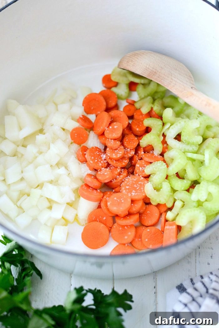 Ingredients for Homemade Turkey Pot Pie Soup laid out on a cutting board, including diced vegetables, turkey, and herbs. Keywords: homemade, turkey, potpie, soup, leftover, fromscratch, thanksgiving, leftovers