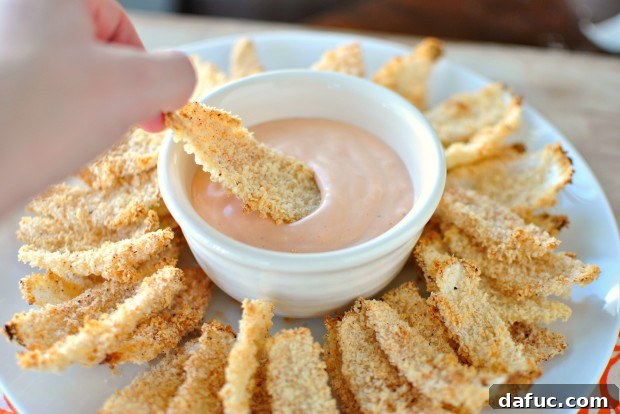 Golden Baked Onion Blooms with Zesty Fry Dip 17 Dunking onion petal in fry sauce