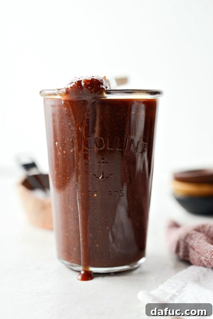 A jar of freshly made Homemade Sweet Barbecue Sauce, perfect for grilling and dipping, showcasing its rich color and smooth texture.