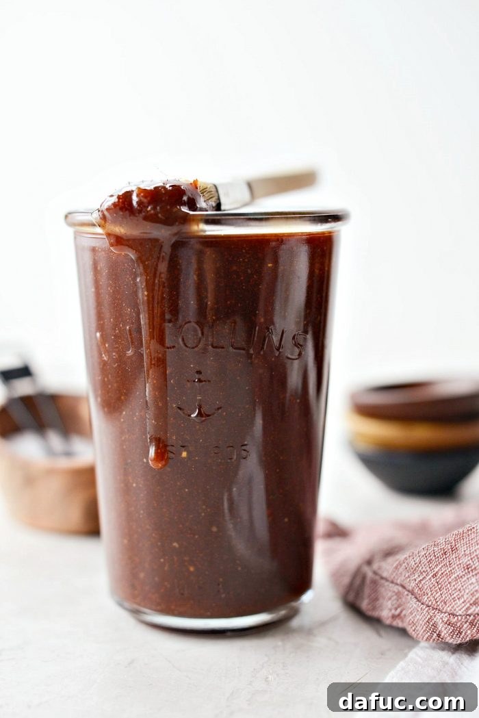 A sealed jar of homemade sweet barbecue sauce in the refrigerator, emphasizing the importance of chilling for flavor development.