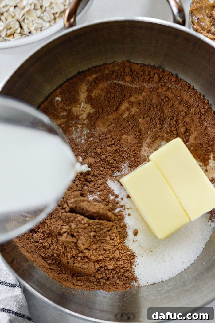 Fudgy No-Bake Oatmeal Delights 6 Pouring whole milk into the chocolate mixture in a saucepan