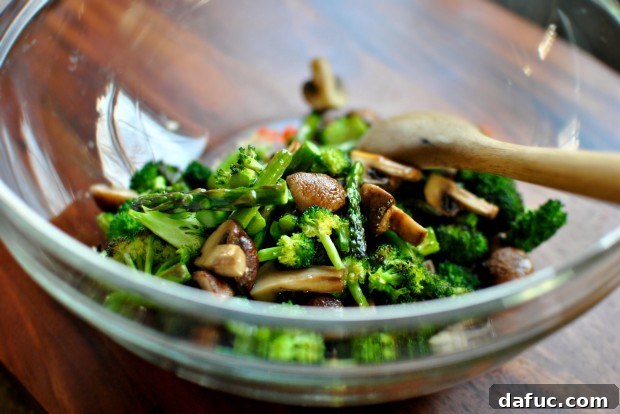 Golden Roasted Vegetable Primavera Pasta 11 Adding roasted vegetables to the bowl