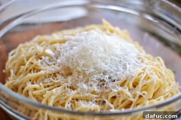Golden Roasted Vegetable Primavera Pasta 17 Adding Parmesan cheese to the pasta