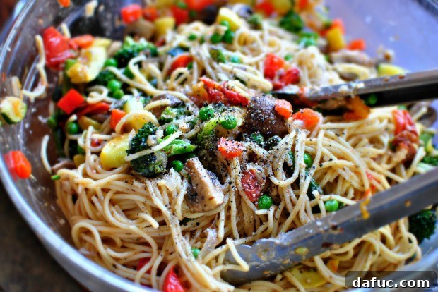 Golden Roasted Vegetable Primavera Pasta 18 Tossing pasta with salt and pepper