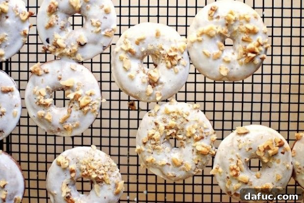 Sunrise Banana Walnut Doughnuts 2 Delicious baked Banana Walnut Breakfast Doughnuts with a creamy glaze and chopped walnuts