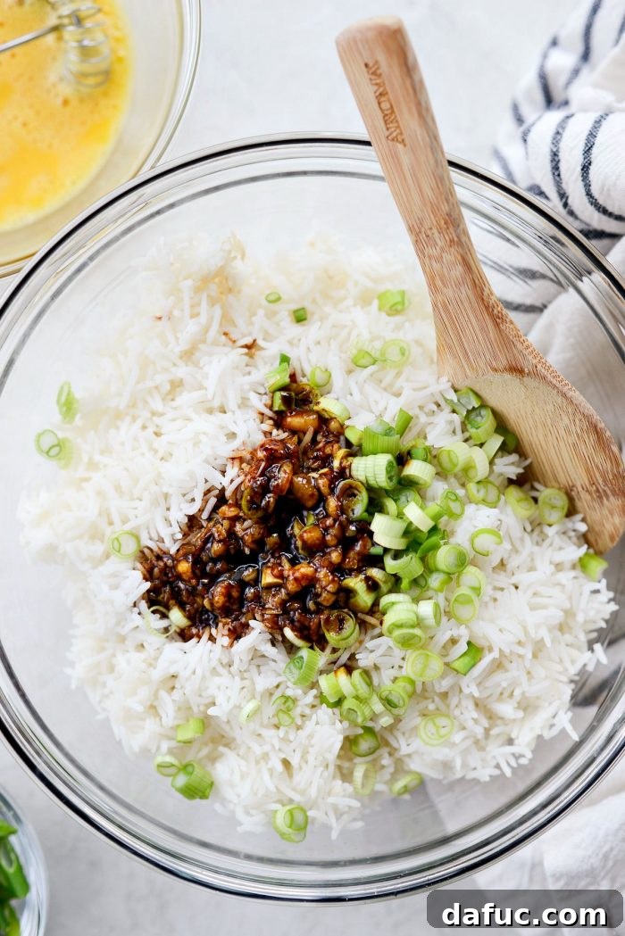 Effortless Fried Rice 8 Pouring the homemade five-ingredient sauce over the rice and green onions mixture