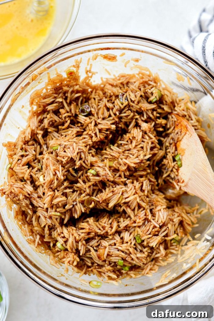 Effortless Fried Rice 9 Tossing rice thoroughly with the sauce and green onions in a large bowl