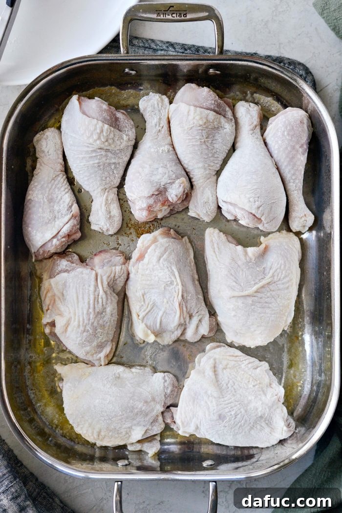 Classic Comfort Baked Chicken 13 Chicken pieces arranged in the roasting pan for the first bake