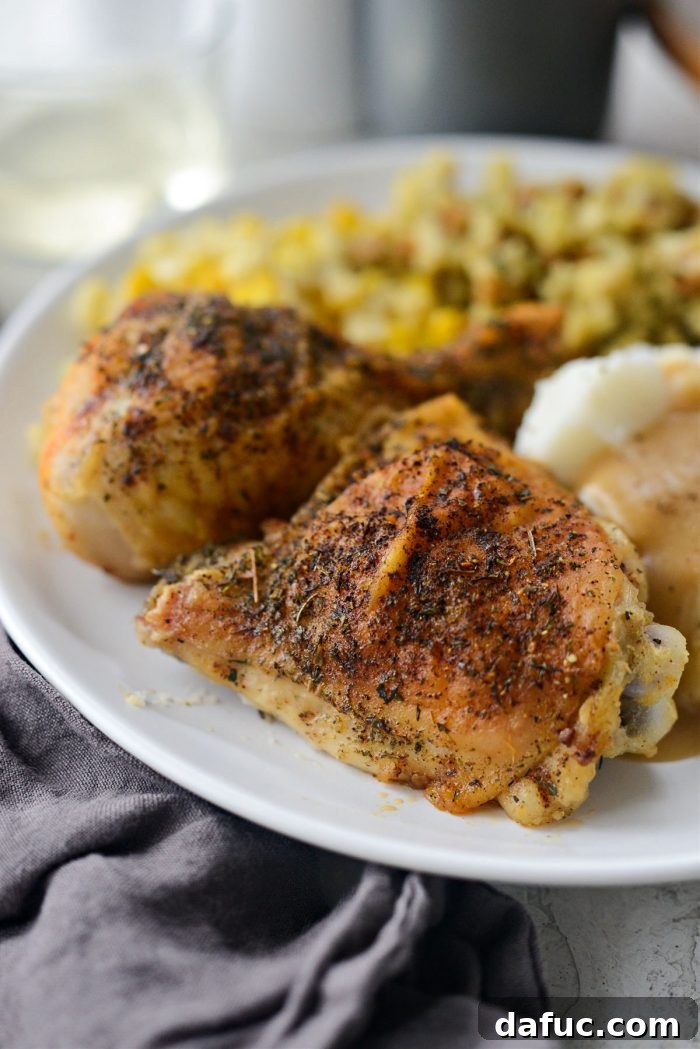 Classic Comfort Baked Chicken 3 Two plates of Homestyle Baked Chicken with Gravy, mashed potatoes, and corn