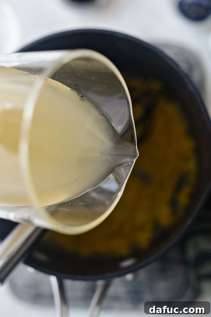 Classic Comfort Baked Chicken 22 Pouring chicken broth into the roux to make gravy