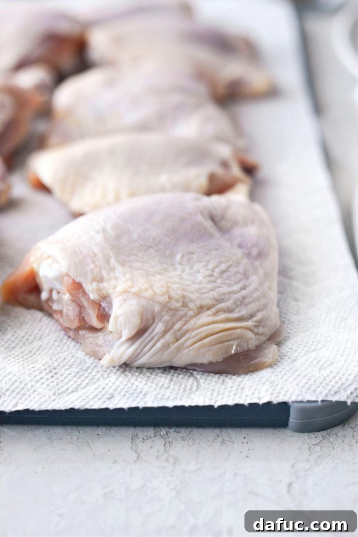 Classic Comfort Baked Chicken 7 Patting chicken dry with paper towel