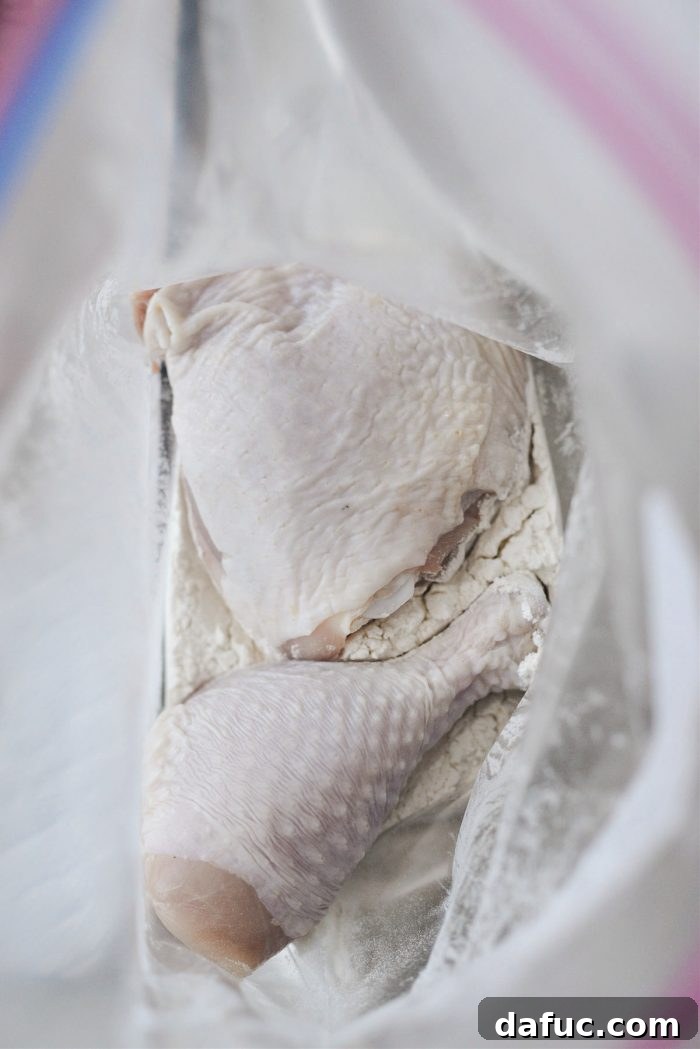 Classic Comfort Baked Chicken 9 Adding chicken to flour in a bag and shaking to coat