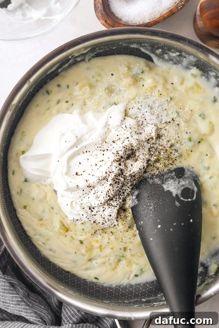 Two-thirds of the freshly grated sharp cheddar cheese added to the creamy sauce