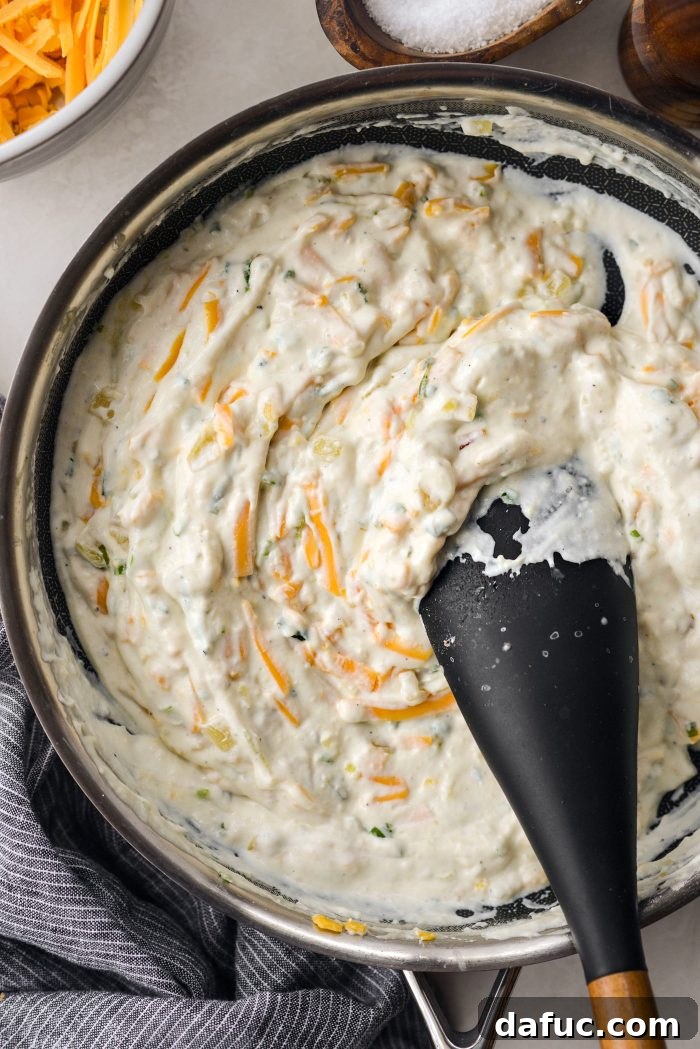 Thoroughly combined cheesy potato mixture in a large mixing bowl