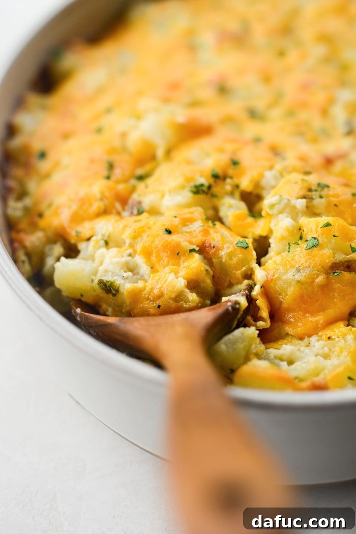 Homemade Cheesy Potatoes in a white baking dish, ready to be served