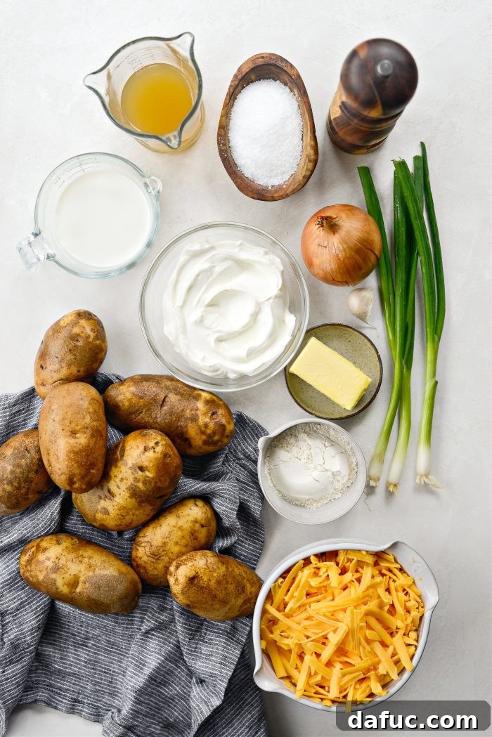 Ingredients laid out for Homemade Cheese Potatoes, including potatoes, cheese, and aromatics