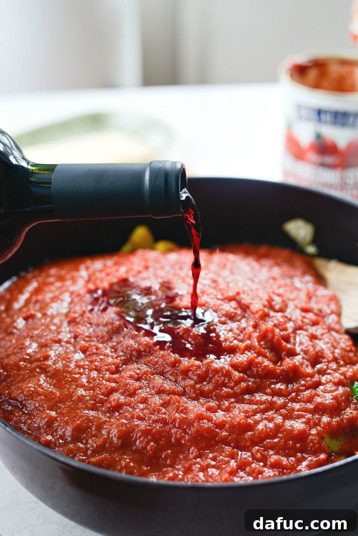 Rustic Garden Ragu 12 Red wine being poured into the vegetable ragu sauce