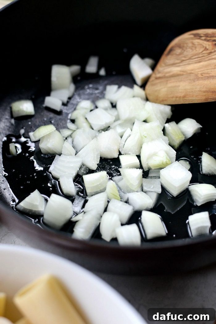 Rustic Garden Ragu 5 Diced yellow onion sautéing in olive oil in a deep skillet