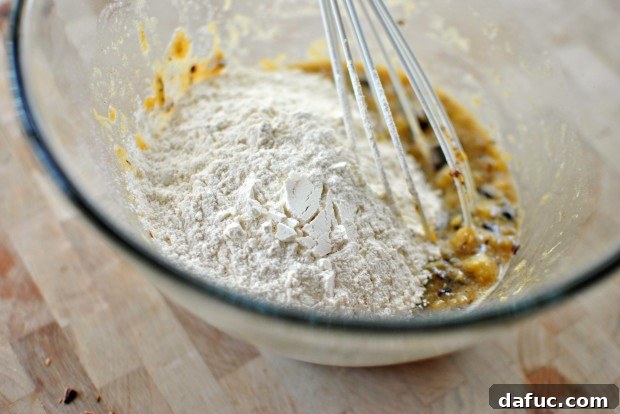 Adding dry muffin ingredients to the wet mixture