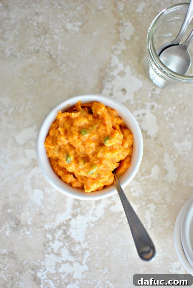 A close-up shot of the creamy Sweet Potato Jalapeño Mash in a small white bowl, showing its inviting texture.