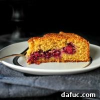 Close-up of a slice of Honey Butter Blackberry Lemon Polenta Cake