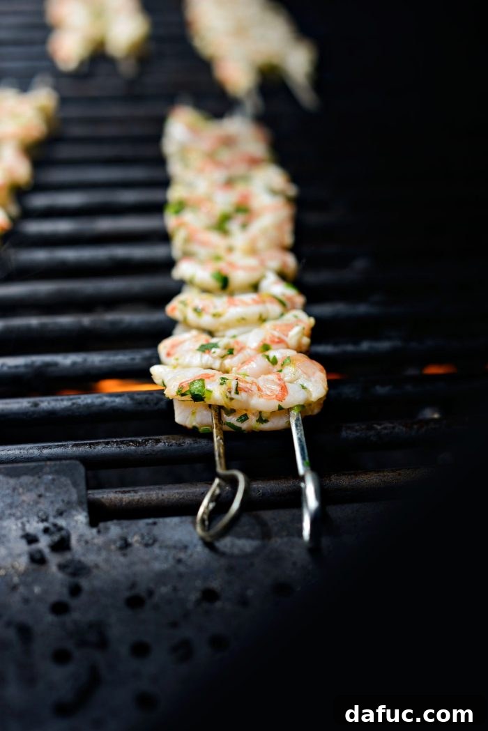 Garlic cilantro lime shrimp skewers cooking on a preheated grill