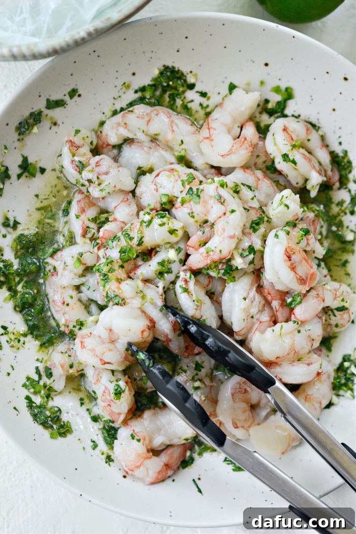 Shrimp being tossed in the garlic cilantro lime marinade