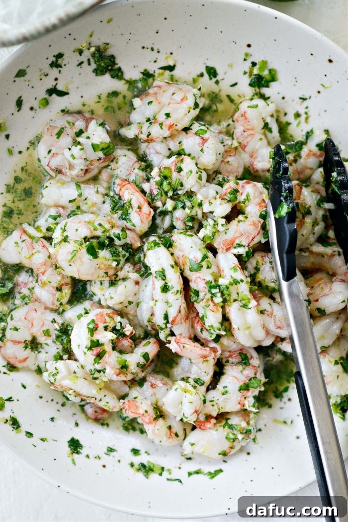 Marinated shrimp resting in the shallow dish before skewering
