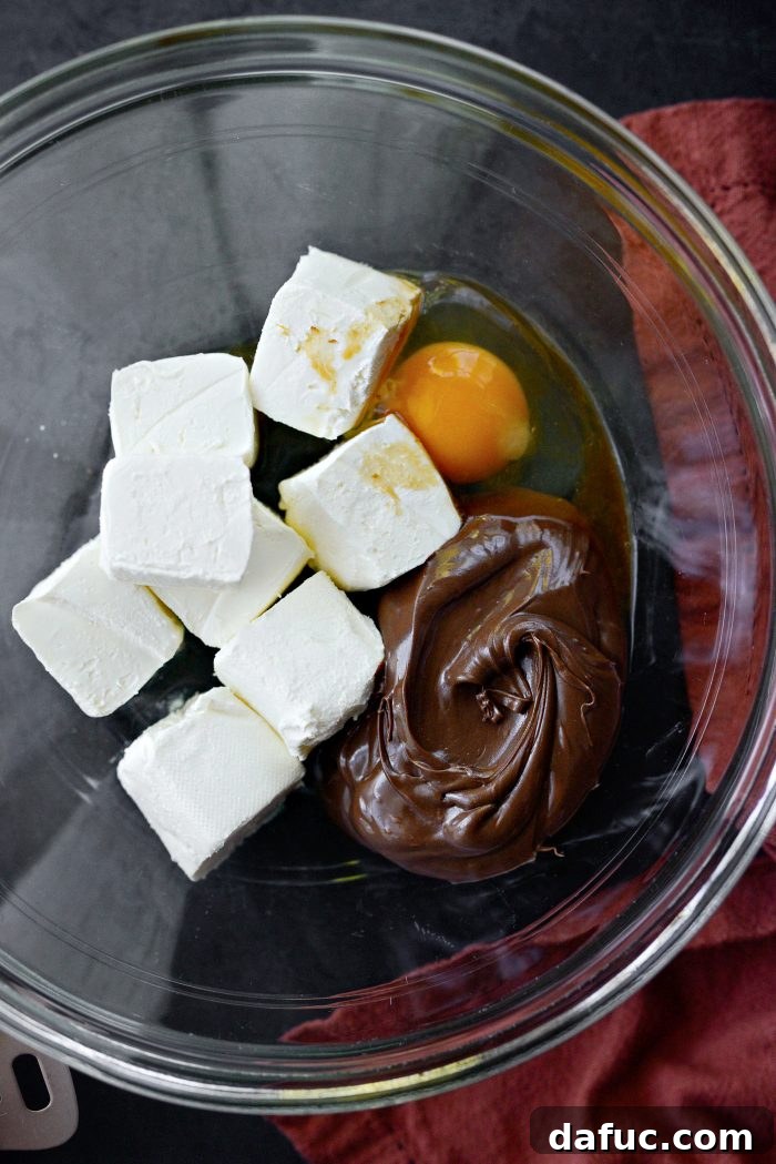 Nutella Ribbon Pumpkin Cheesecake Muffins 12 add cheesecake filling ingredients in a bowl