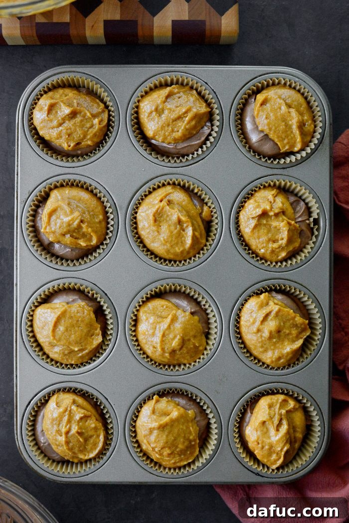 Nutella Ribbon Pumpkin Cheesecake Muffins 16 top with 2T more batter
