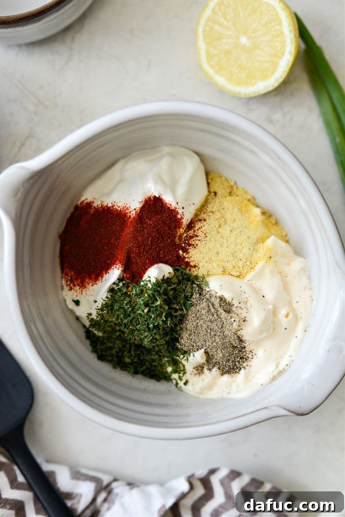 Mayonnaise, sour cream, herbs and spices in a bowl