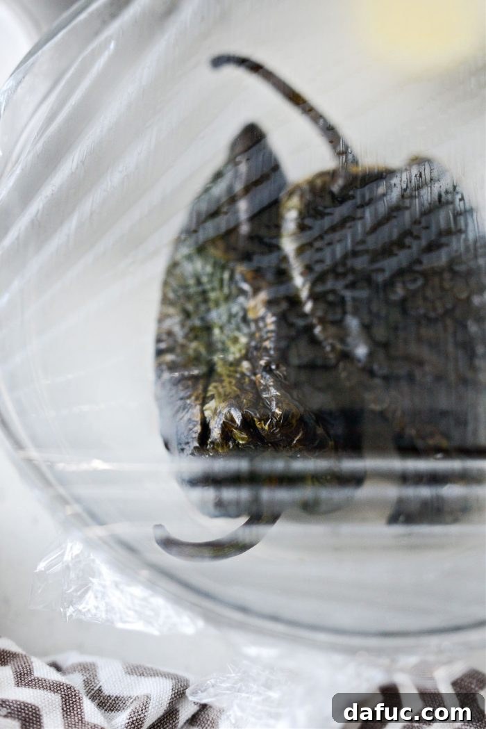 Poblano peppers covered with plastic wrap to steam