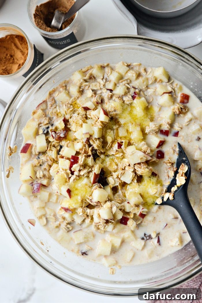 Warm Apple Cinnamon Oat Bake 8 Stirring the oatmeal mixture and adding melted butter into the bowl for richness