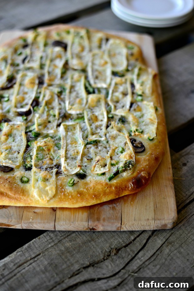 Delicious Asparagus, Mushroom, and Shallot Flatbread on a baking sheet, ready to be enjoyed.