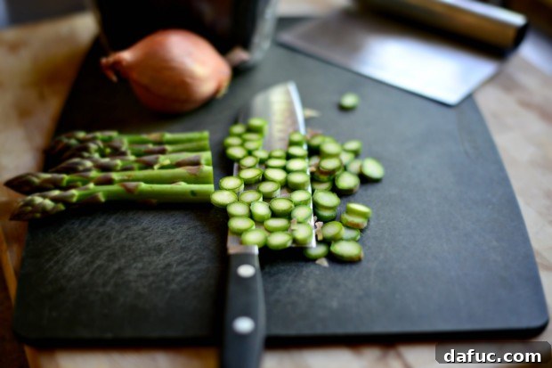 Thinly sliced asparagus tips laid out, ready for use on the spring vegetable flatbread.
