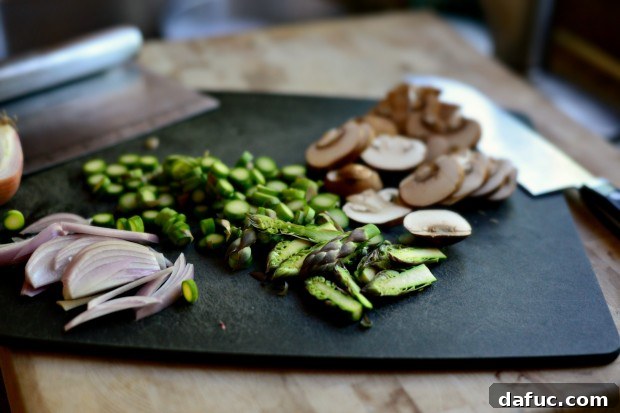 Thinly sliced shallots arranged, showcasing their delicate layers and readiness for the flatbread.