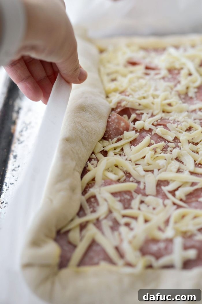 From Scratch Stromboli 19 use the parchment to roll the dough towards the 2-inch overhang