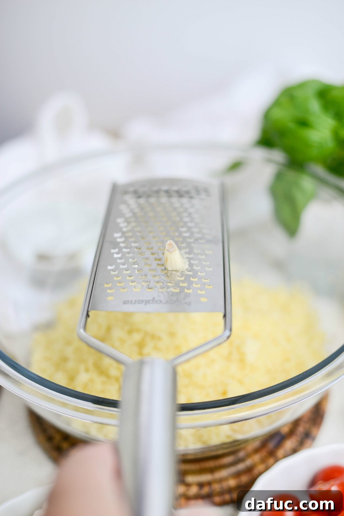 Vibrant Caprese Couscous 7 Grated garlic being added to couscous