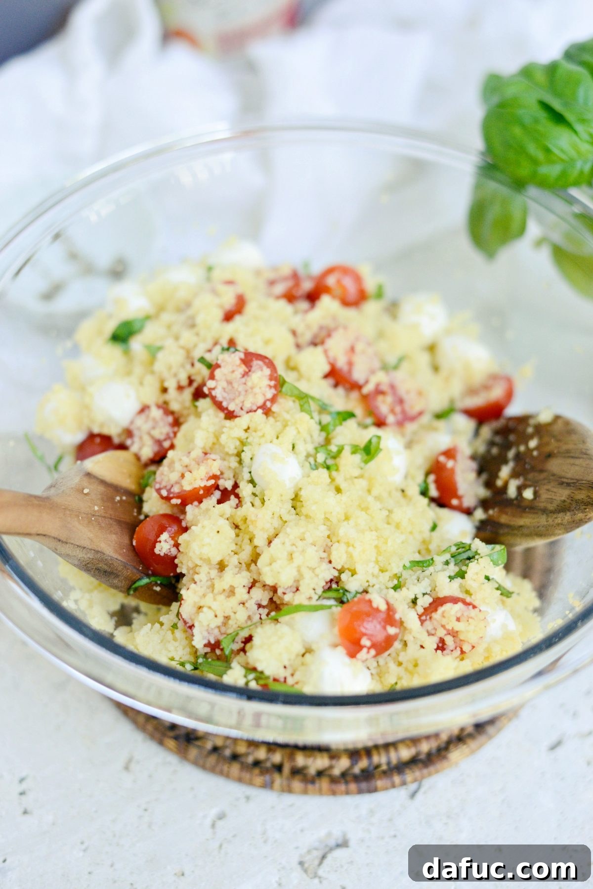 Vibrant Caprese Couscous 9 Tossing Caprese Couscous Salad to combine ingredients