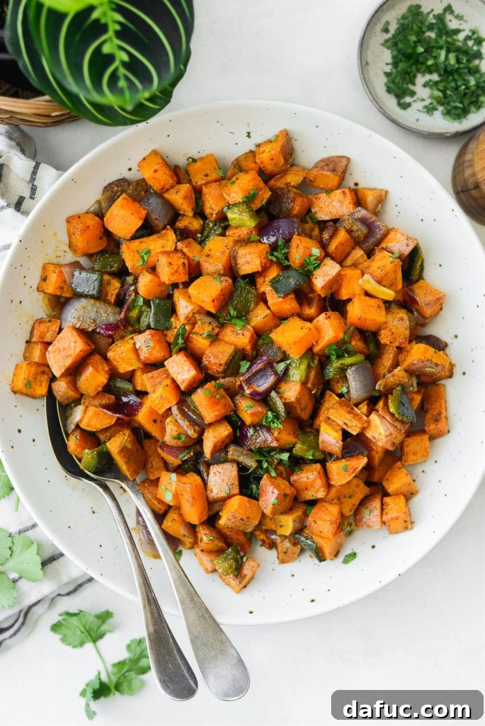 Close-up of baked Sweet Potato Home Fries, ready to be seasoned.