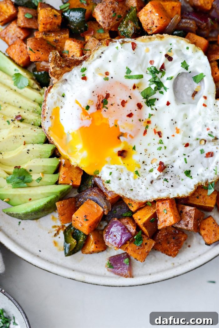 Final plated image of Sweet Potato Home Fries with an egg and avocado.