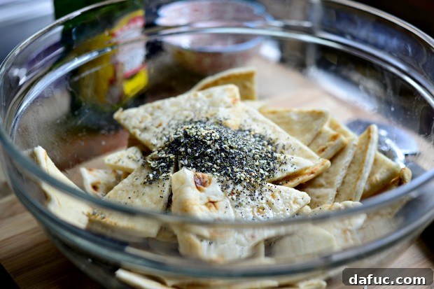 Everything Seasoned Pita Crisps 11 Tossing pita wedges with olive oil for an even coat