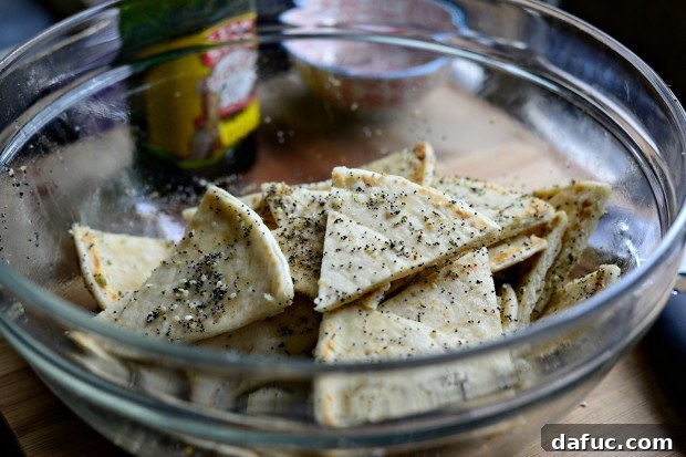 Everything Seasoned Pita Crisps 12 Sprinkling Everything seasoning over olive oil-coated pita wedges