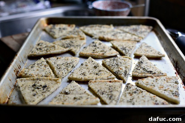 Everything Seasoned Pita Crisps 13 Using hands to toss pita triangles with seasoning for even distribution