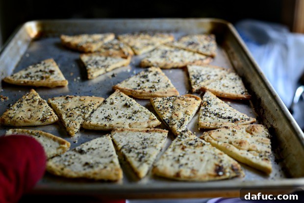 Everything Seasoned Pita Crisps 14 Baked Everything Pita Chips cooling on a wire rack after baking