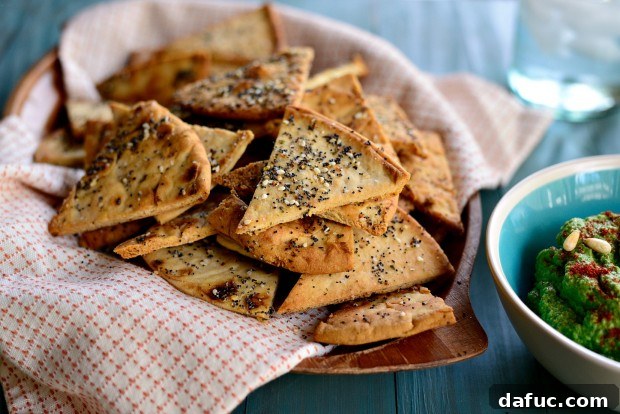 Everything Seasoned Pita Crisps 17 Final plated image of Everything Baked Pita Chips with a bowl of hummus