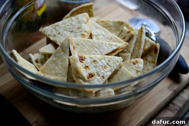 Everything Seasoned Pita Crisps 10 Drizzling light olive oil over pita wedges in a mixing bowl