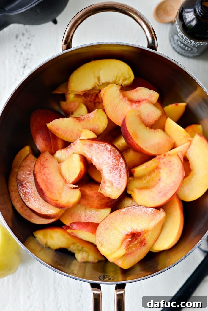 Freshly sliced peaches in a saucepan, ready for cooking