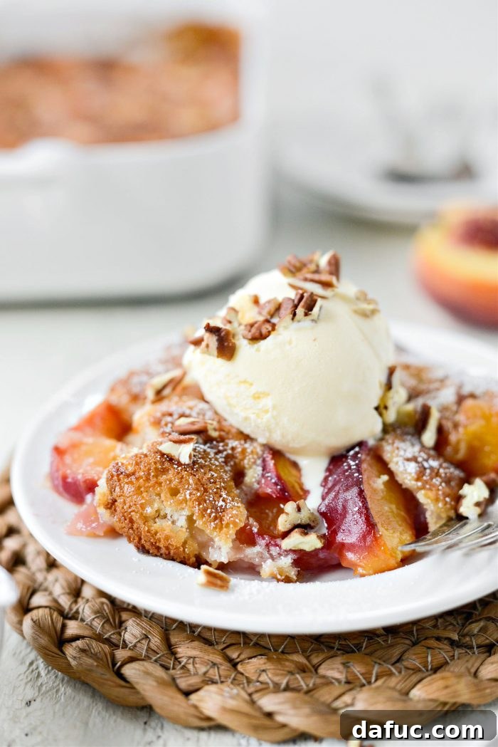 Brown Butter Peach Cobbler served with a scoop of ice cream and a sprinkle of chopped pecans