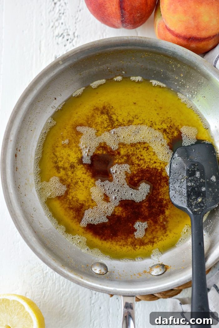Unsalted butter melting and browning in a stainless steel skillet